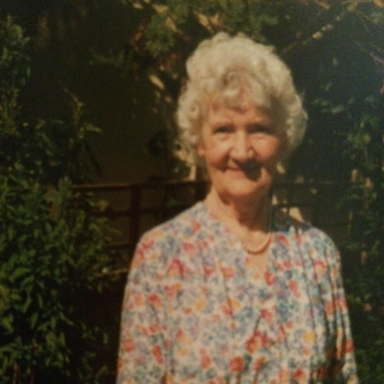 Edith Edwards smiling outdoors in a floral blouse