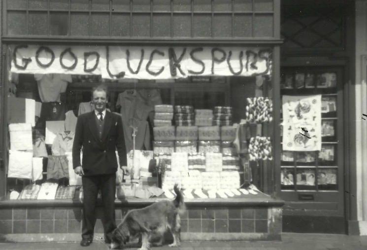 Stan Edwards standing outside a shop with a dog
